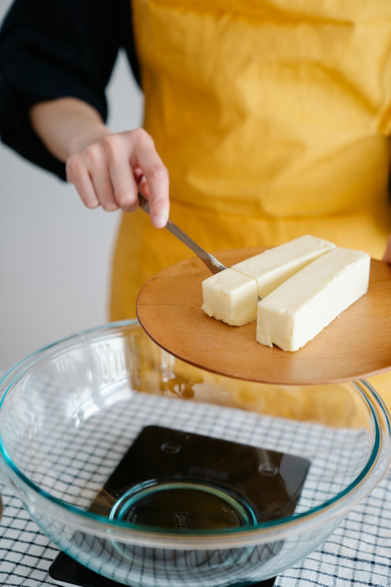 adding butter to a mixing bowl